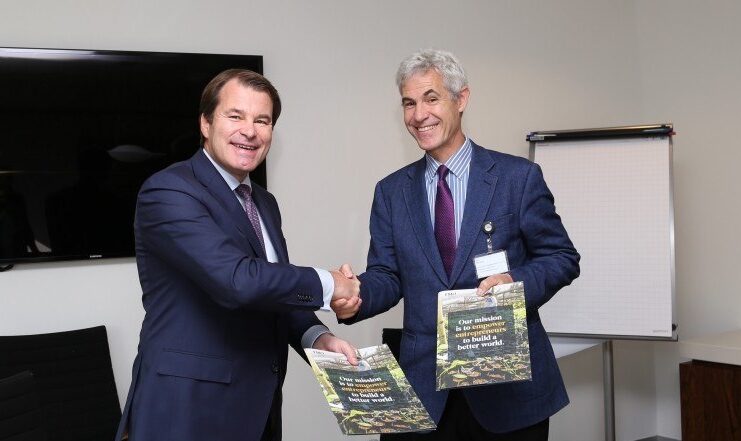 Shell Foundation Director Sam Parker shaking hands with FMO CEO Jurgen Rigterink